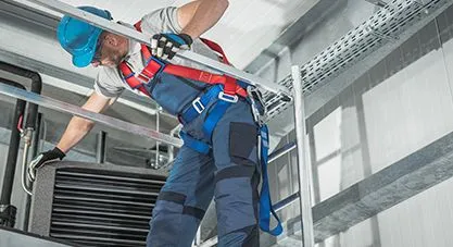 An HVAC technician working on commercial equipment